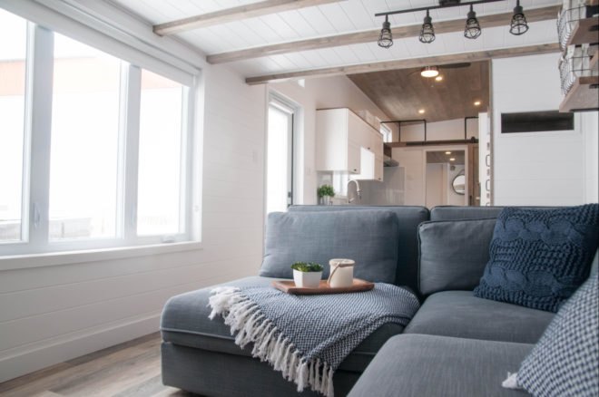 grey sofa with blanket and tray