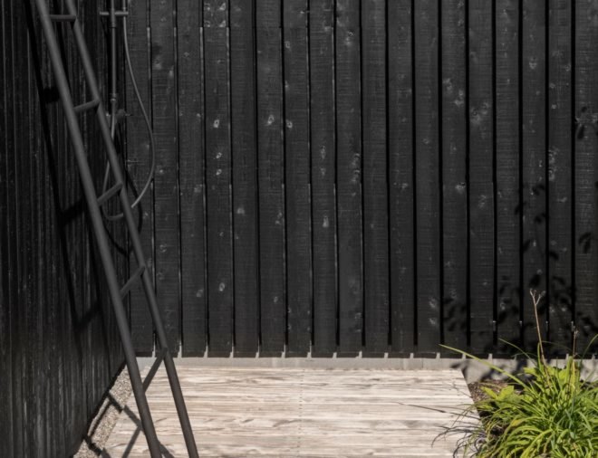 black wall with black ladder