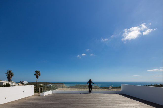 man walking on open-air wooden deck
