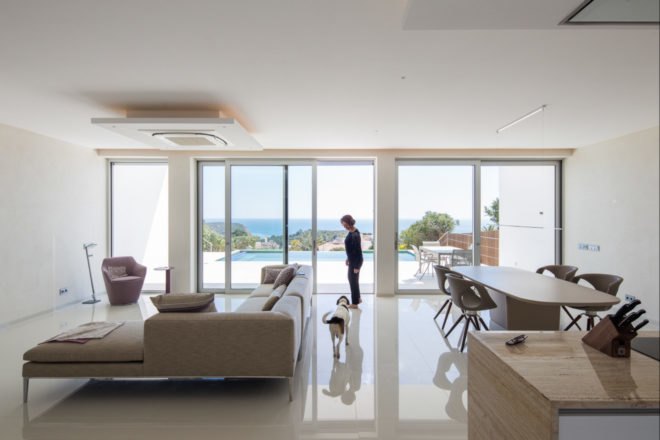 interior living space with all glass wall and gray couch