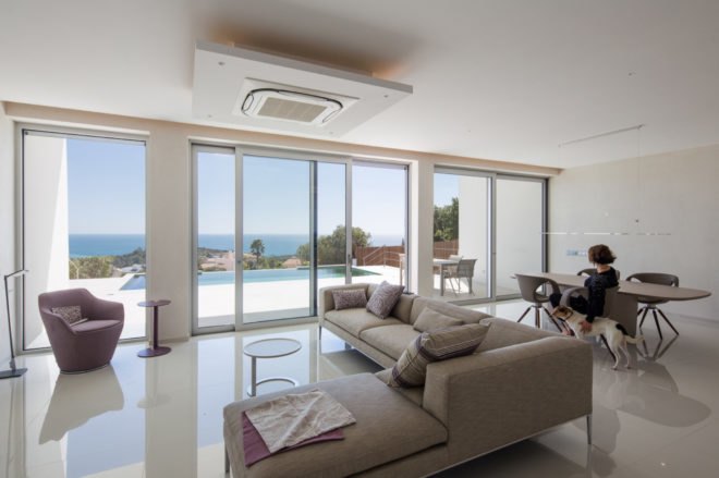 interior living space with all glass wall and gray sectional sofa