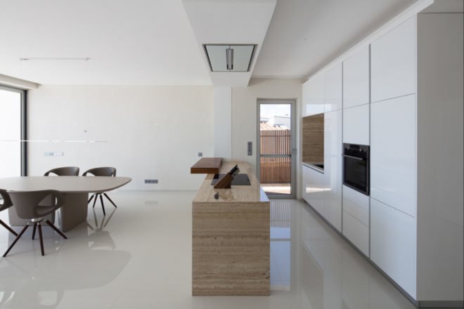 all-white kitchen with wooden island