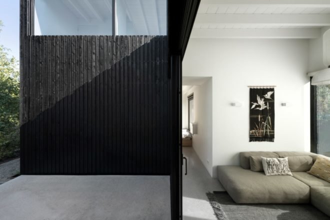 all black door opening to living space