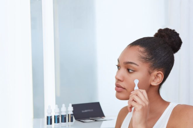 person applying skincare to face