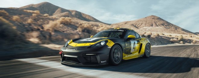 exterior of black and yellow porsche cayman on race track