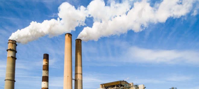 power plant with emissions pouring out