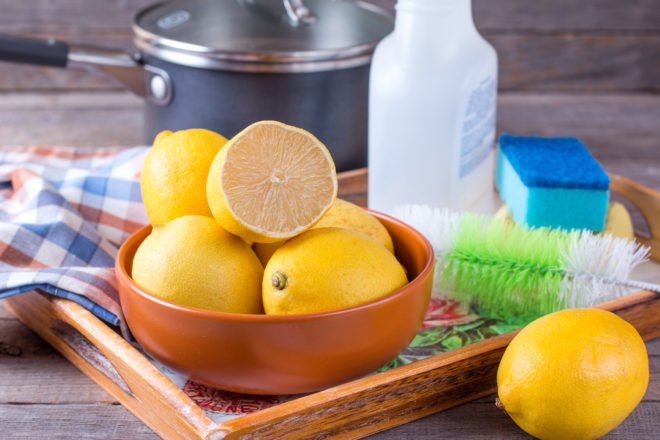 bowl of lemons and sprat bottle with pot and sponge