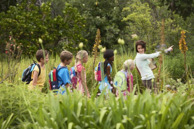 teacher and kids on a nature walk