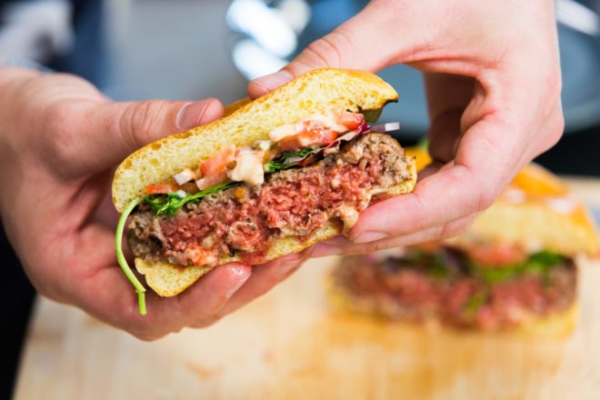 person holding medium-well veggie patty