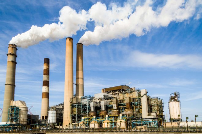 power plant with emissions pouring out
