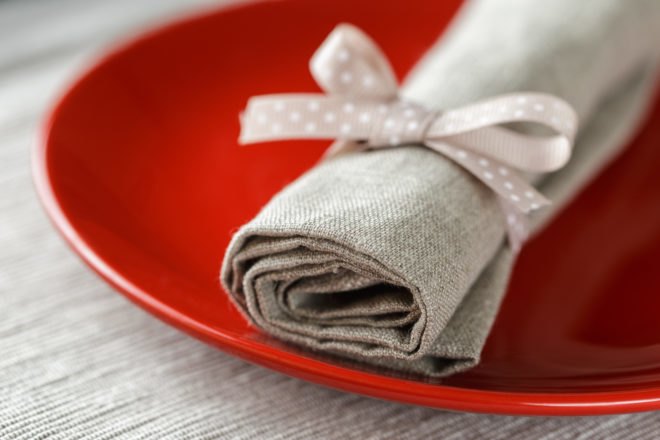 gray cloth napkin over red plate