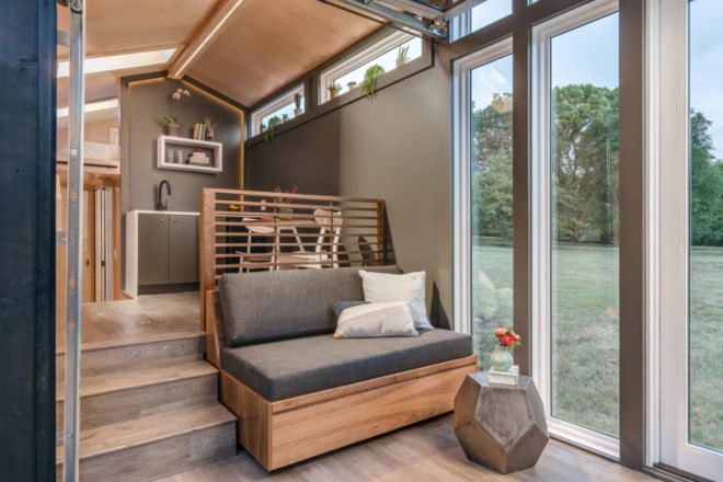 small gray sofa near windows
