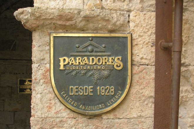 black and gold Paradores sign on a building