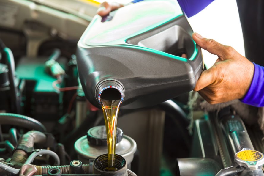 motor oil being poured into vehicle's hood