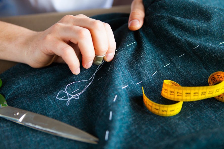 person sewing fabric
