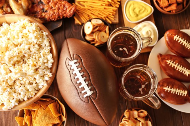 flat lay of football, popcorn, cookies and beer