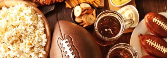 flat lay of football, popcorn, cookies and beer