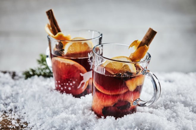 glass mugs filled with wassail in snow