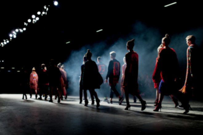models walking on a foggy runway