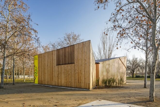 wood classroom building with yellow signage