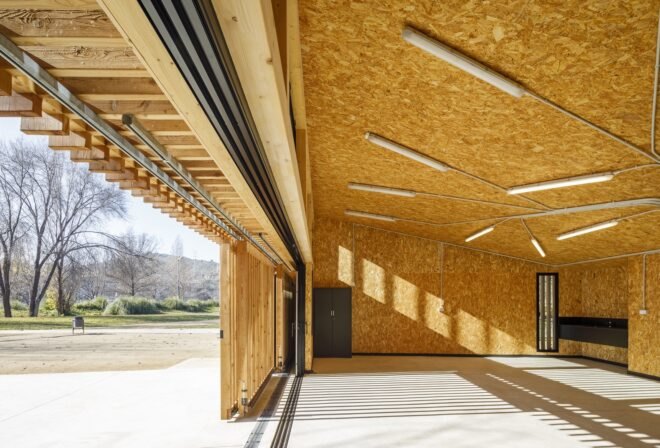 timber-lined room with large open door