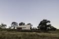 stone home surrounded by wild grasses