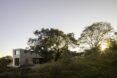 trees in front of a stone home
