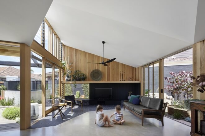 living area with wood furniture and painted brick and tile floors with lots of windows