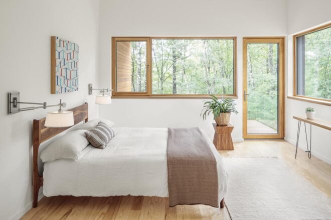 white walls in the bedroom with timber window trimmings illuminate the bedroom