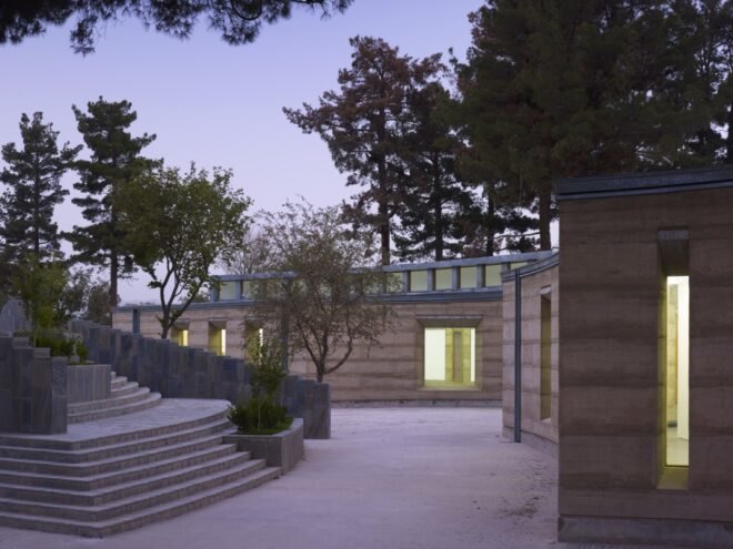 steps leading down to a rammed earth building