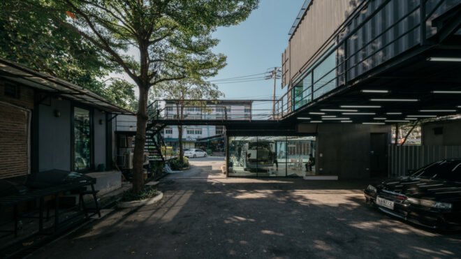 black shipping container with lower level storage areas for cars
