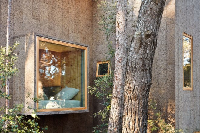a cork-clad structure with a large window
