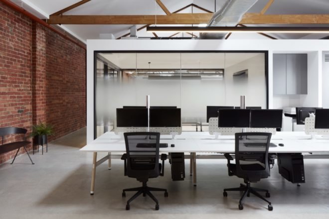 brick and white walls in the interior of the warehouse with metal furnishings