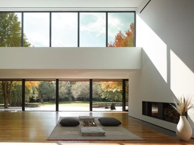 white room with several glass windows and a modern fireplace