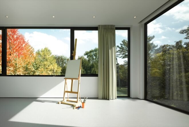 white room with glass walls and an easel