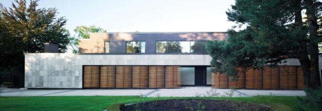 gray home with timber screens in front