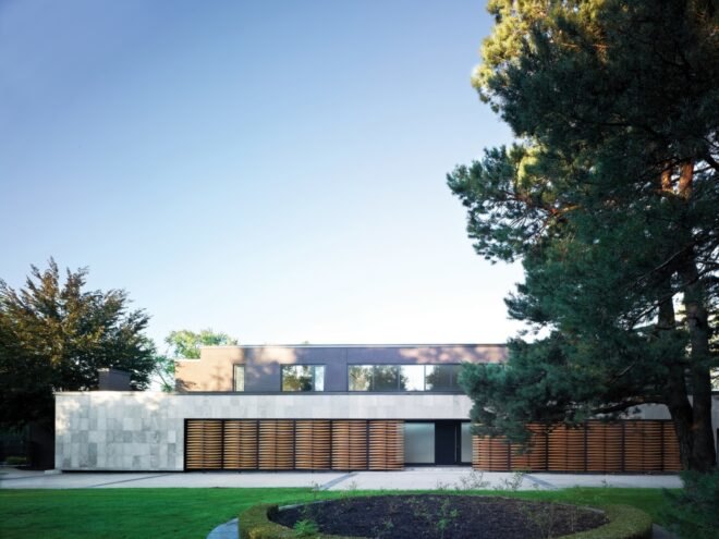 gray home with timber screens in front