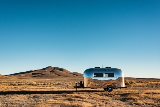 silver airstream trailer in a desert landscape