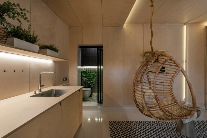 wood kitchen with a hanging wicker chair nearby