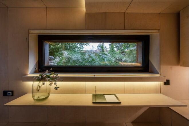 wooden kitchen counter with vase of flowers