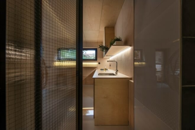 door opening to wood-lined kitchen
