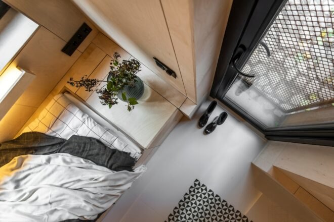 aerial view of bedroom with wood walls