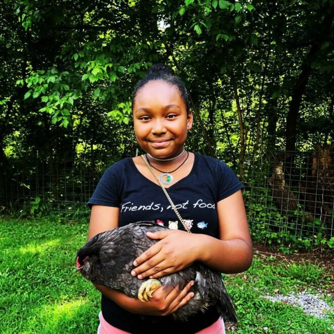 Genesis Butler holding a chicken