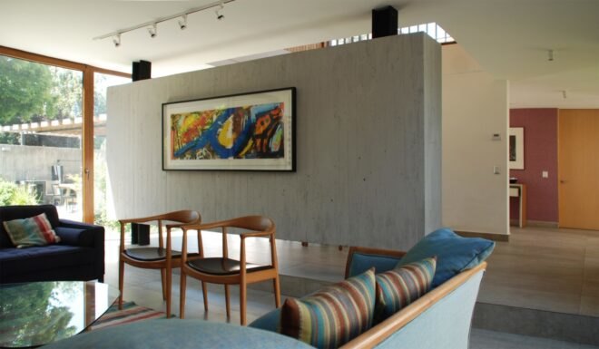 gray living room with blue couches and colorful wall art