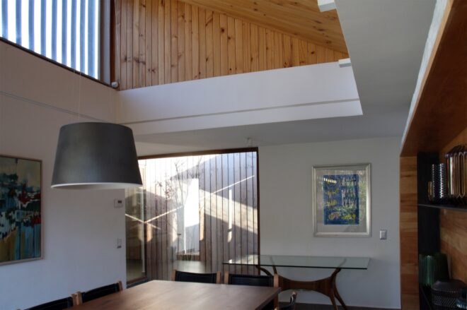 white living room with double-height wood ceiling