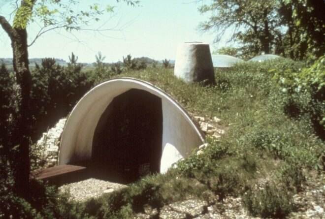 arched structure covered in natural vegetation