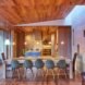 long dining table with many chairs in wood-lined room