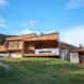 wooden and rammed earth home at the top of a hill