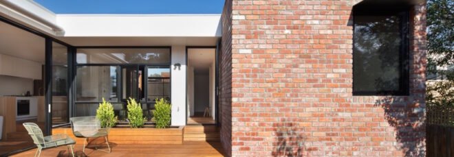 brick home with wood patio