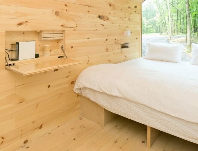 bed with all-white linens in small cabin